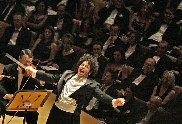 Gustavo Dudamel throws himself into his conducting during his inaugural performance at Walt Disney Concert Hall as new music director of the Los Angeles Philharmonic.