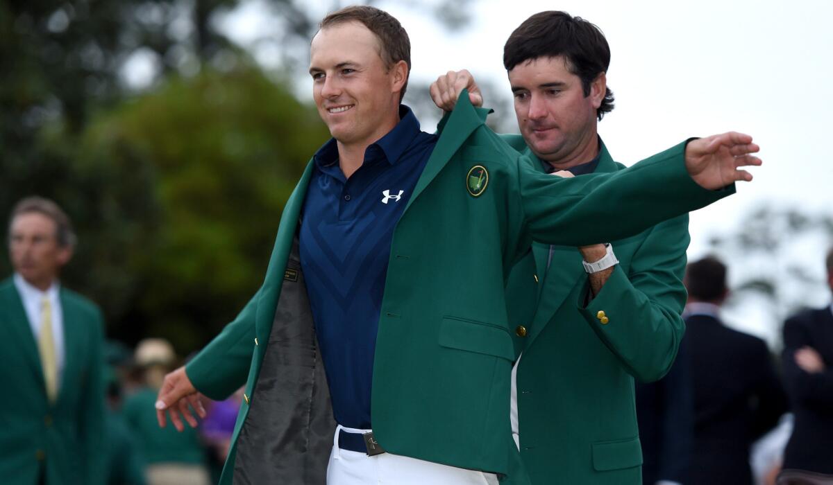 Jordan Spieth receives his green jacket from last year's Masters champion Bubba Watson on Sunday at Augusta National Golf Club.