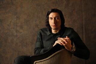 Actor Adam Driver sitting and leaning on a chair
