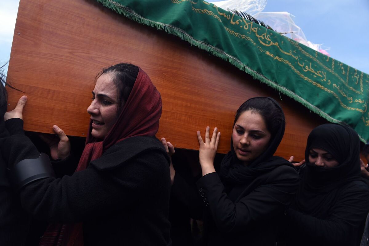 Women carry the coffin Sunday of a woman who was beaten and burned to death by an angry mob in Kabul, Afghanistan.