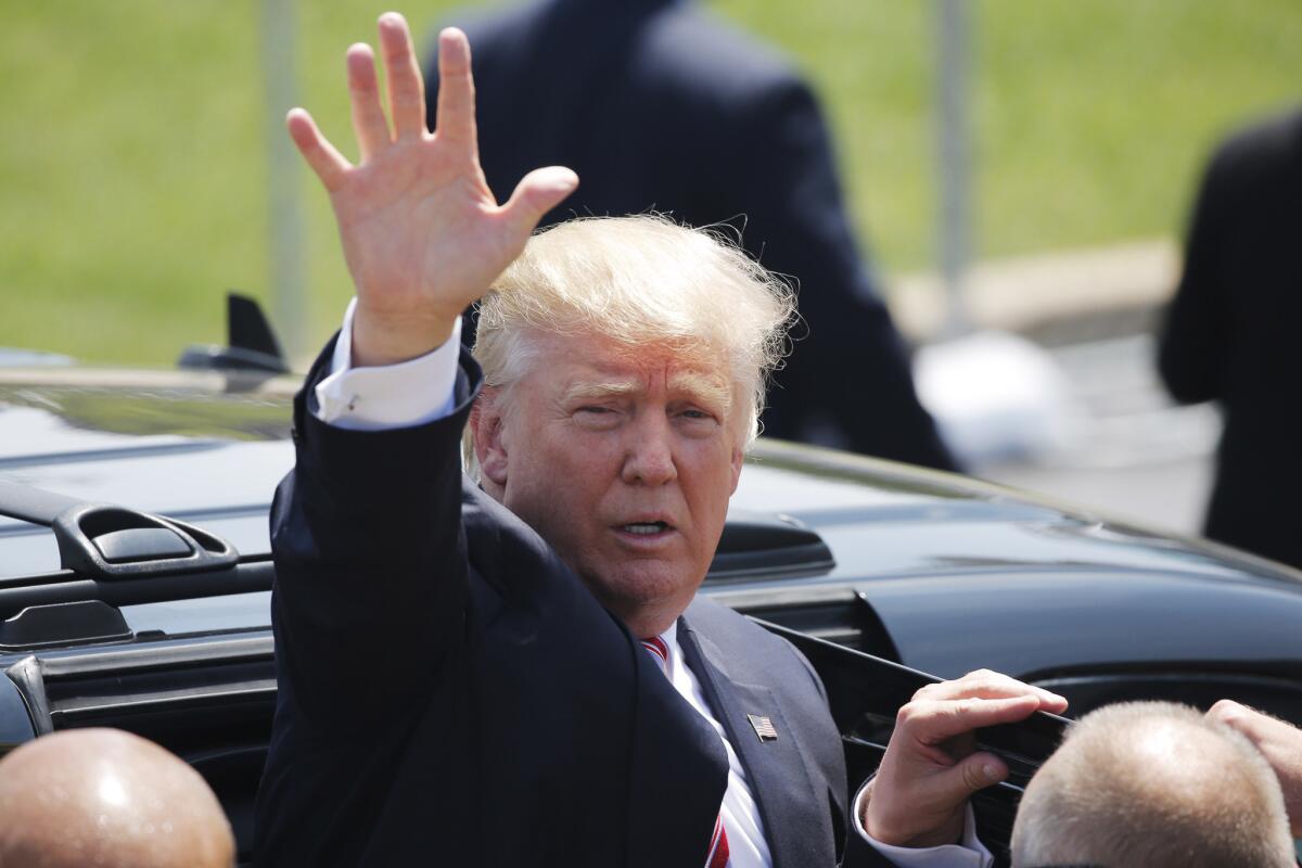 Donald Trump waves to supporters in Cleveland on Wednesday as he arrives at the Republican National Convention.