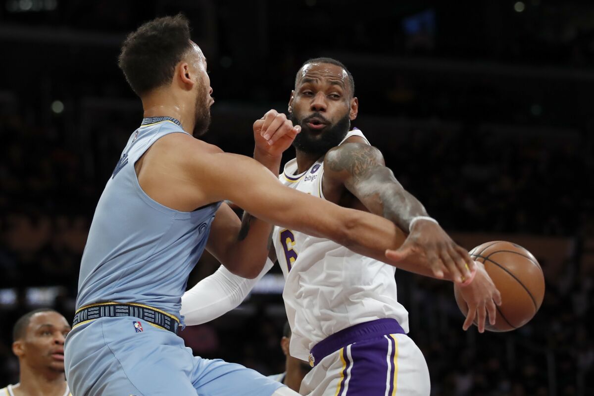Lakers forward LeBron James tries to disrupt a pass by Grizzlies forward Kyle Anderson.