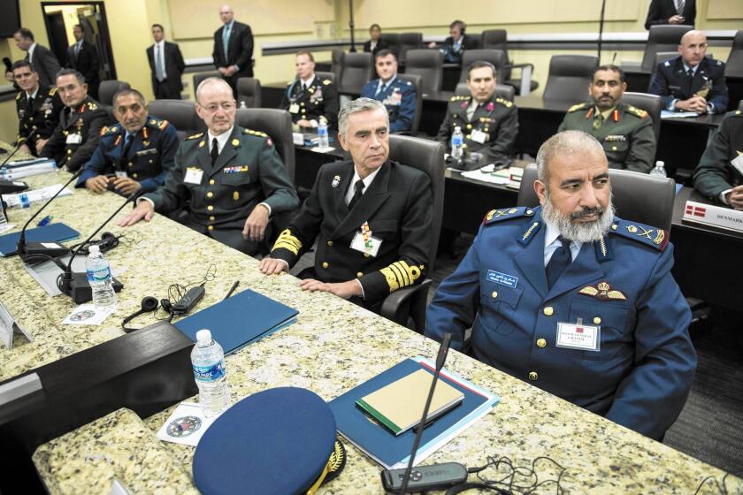 Defense chiefs from Turkey, the United Arab Emirates, Denmark, Spain, Qatar and other nations listen to an address by President Obama, not visible, at Andrews Air Force Base in Maryland.