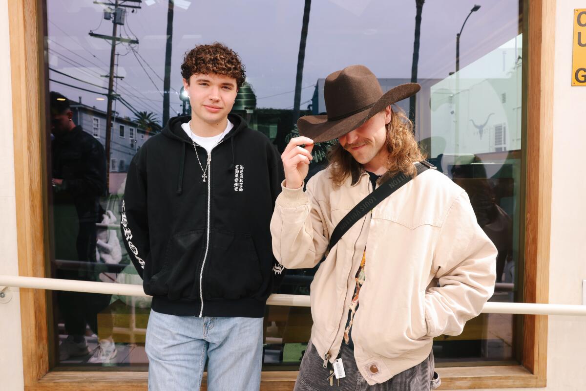 Austin Quire, left, wearing a Chrome Hearts hoodie, and Andrew Tabak wearing a cowboy hat.