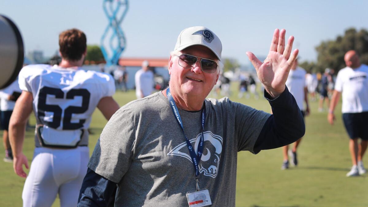 Rams defensive coordinator Wade Phillips waves at fans at the Rams training camp.