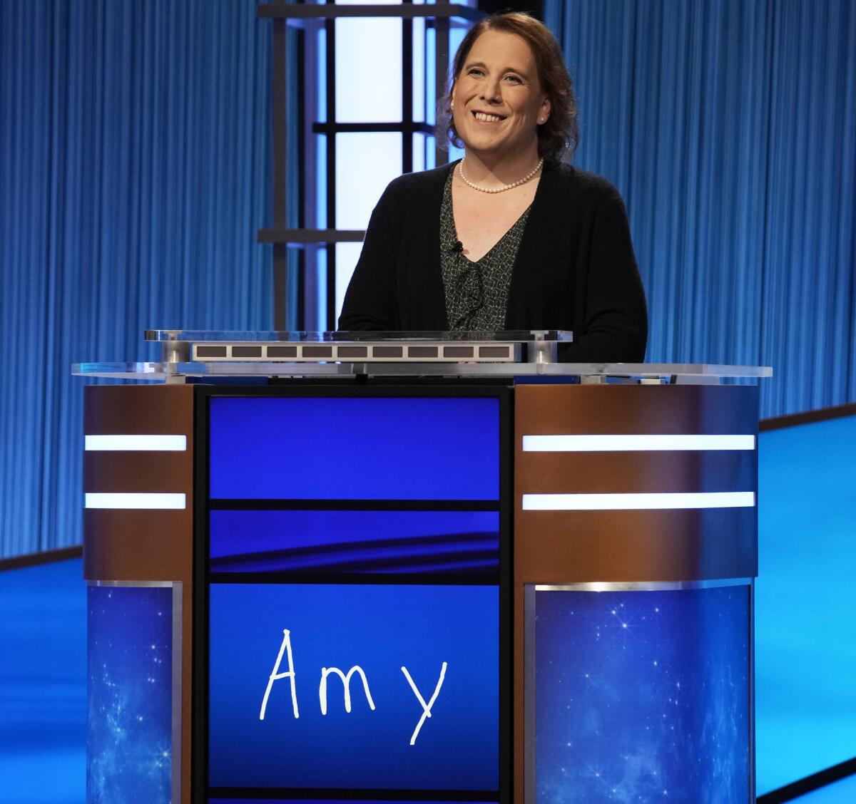 This image provided by Jeopardy Productions, Inc. shows game show champion Amy Schneider on the set of "Jeopardy!" Schneider is the first trans person to qualify for the show's Tournament of Champions. (Jeopardy Productions, Inc. via AP)