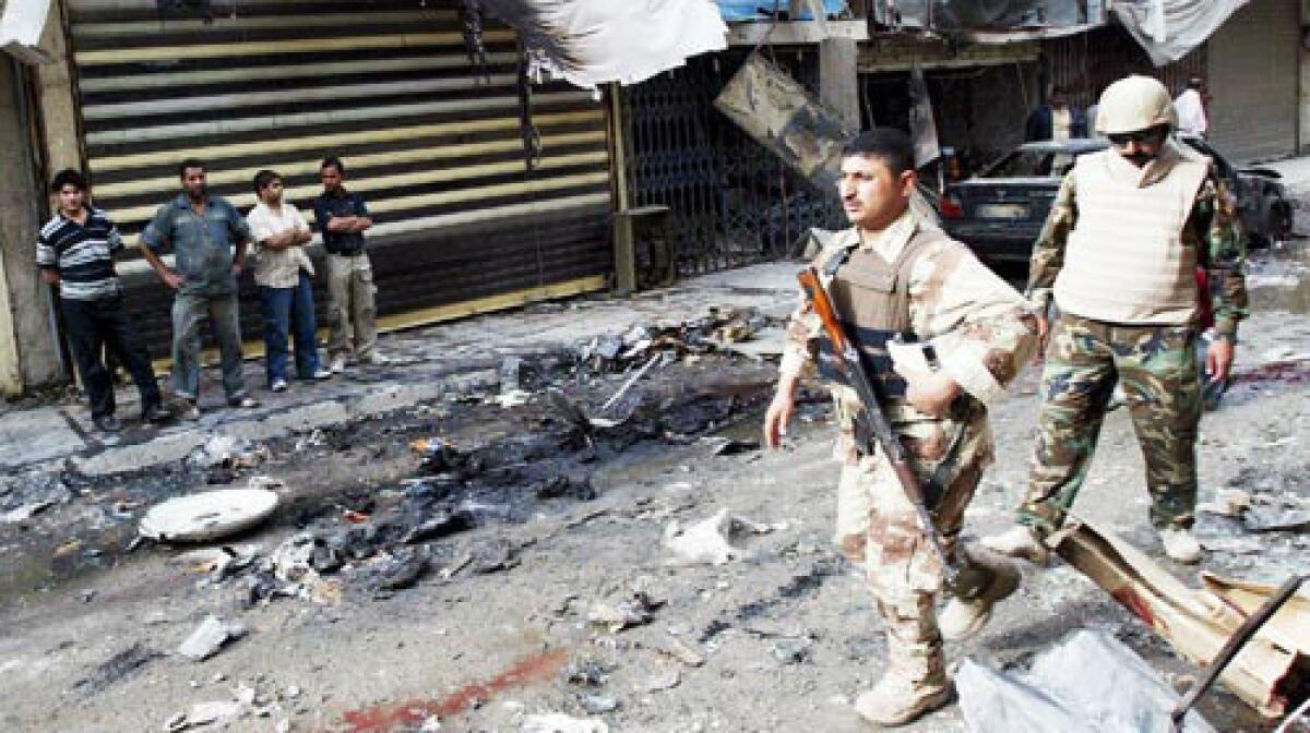 Iraqi soldiers take stock of the damage after a car bomb exploded near the popular Tahrir Square market in central Baghdad. The attack killed 18 people.