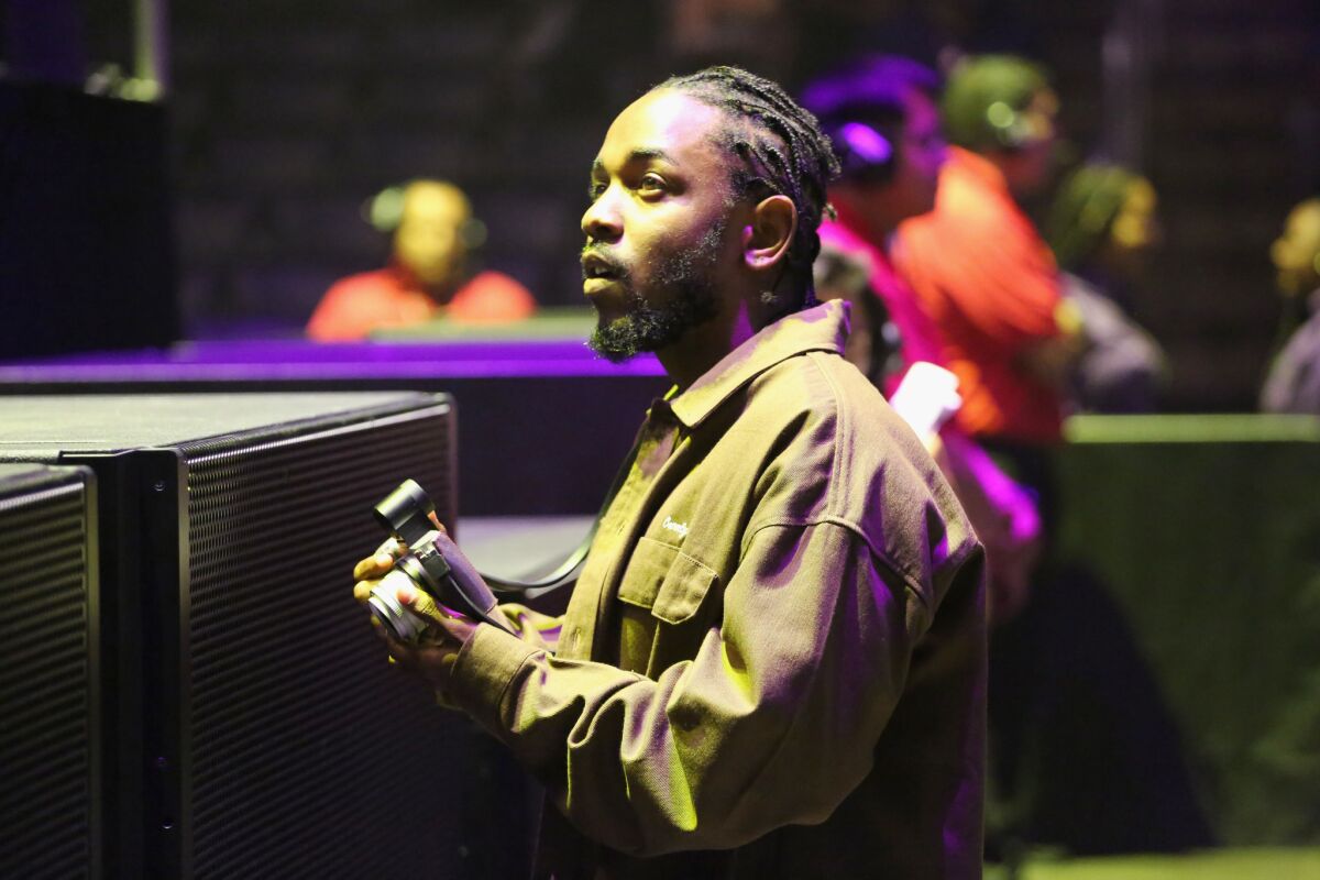 Kendrick Lamar takes in SZA's set at the 2018 BET Experience.