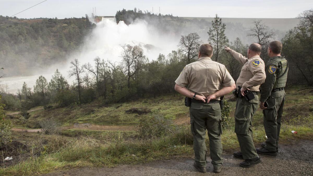 California game wardens view the damaged Oroville Dam spillway on Monday.