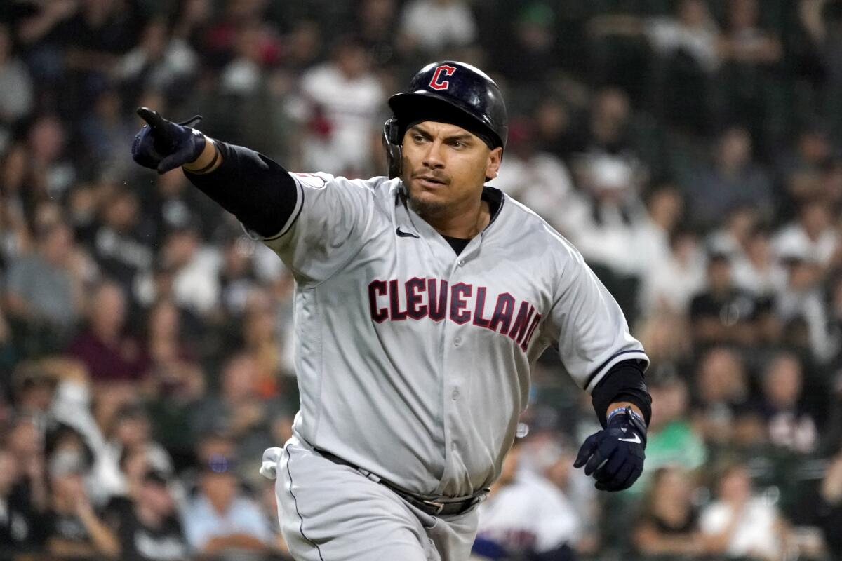Cleveland Guardians' Josh Naylor points to teammates in the dugout after hitting an RBI single off Chicago White Sox relief pitcher Kendall Graveman during the10th inning of a baseball game Tuesday, Sept. 20, 2022, in Chicago. (AP Photo/Charles Rex Arbogast)
