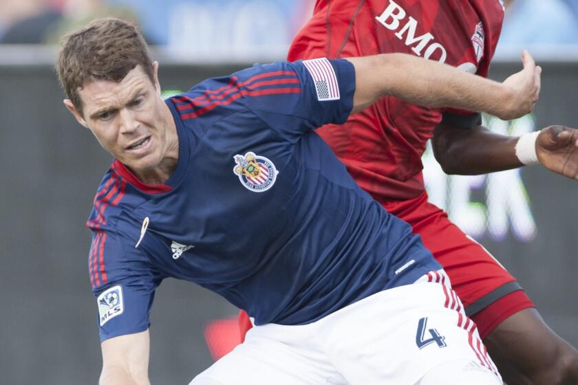 Chivas USA's Tony Lochhead defends against a Toronto FC player during a match on Sept. 21.