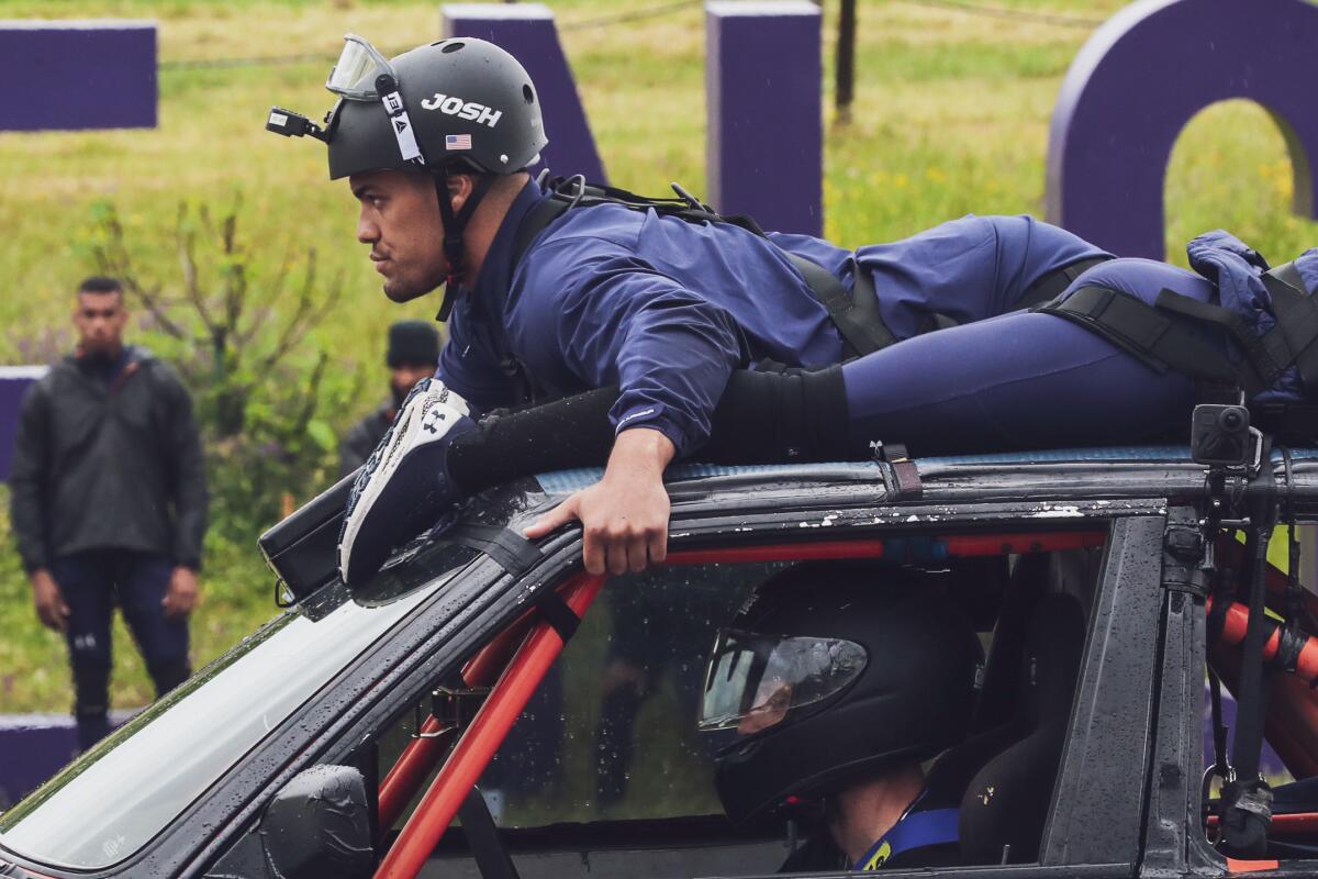 Competitor Josh Martinez (and teammate) atop a car on MTV's "The Challenge: Spies, Lies and Allies."