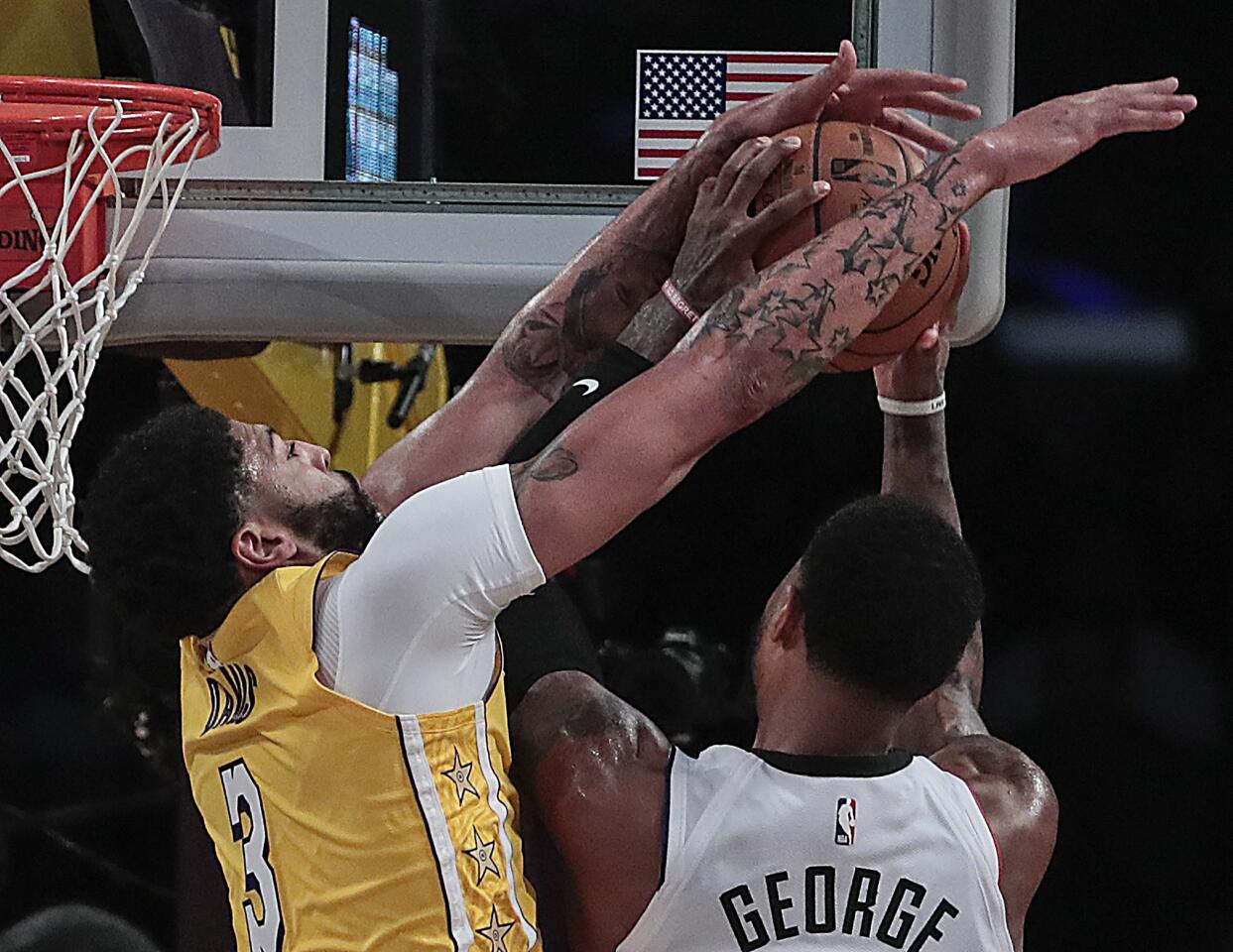 Lakers forward Anthony Davis (3) blocked a shot by Clippers forward Paul George during the first half.