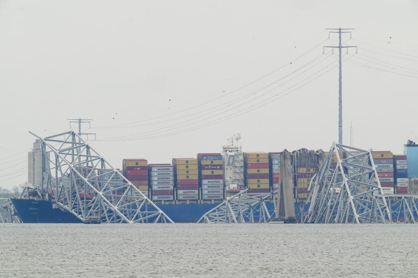 A container ship rests against the wreckage of the Francis Scott Key Bridge on Thursday, March 28, 2024, in Baltimore, Md. The ship rammed into the major bridge in Baltimore early Tuesday, causing it to collapse in a matter of seconds and creating a terrifying scene as several vehicles plunged into the chilly river below. (AP Photo/Matt Rourke)