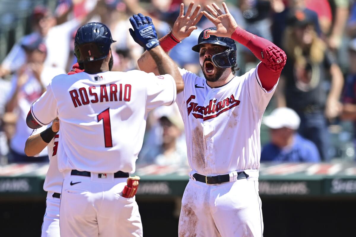 Cleveland Guardians' Amed Rosario, left, is congratulated by Austin Hedges after hitting a three-run home run off Arizona Diamondbacks starting pitcher Tommy Henry during the fifth inning of a baseball game, Wednesday Aug. 3, 2022, in Cleveland. (AP Photo/David Dermer)