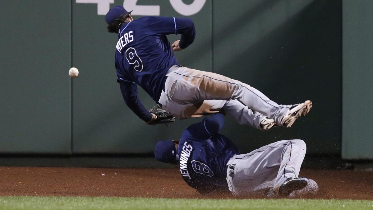 Tampa Bay Rays right fielder Wil Myers, top, and center fielder Desmond Jennings collide while trying to make the play on a winning run-scoring triple by Boston's A.J. Pierzynski during the 10th inning of a 3-2 loss Friday.