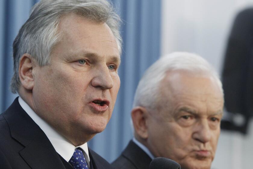 Former Polish President Aleksander Kwasniewski, left, and former Prime Minister Leszek Miller, at a Warsaw press conference Dec. 10 where they confirmed Poland had collaborated in the CIA interrogation of terror suspects after Sept. 11, 2001.