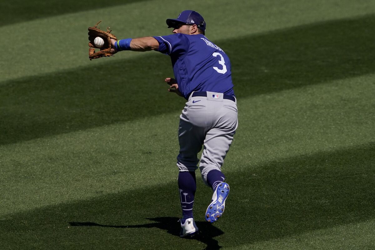 Los Angeles Dodgers' Chris Taylor (3) catches a fly-out hit by Colorado Rockies' Michael Toglia 