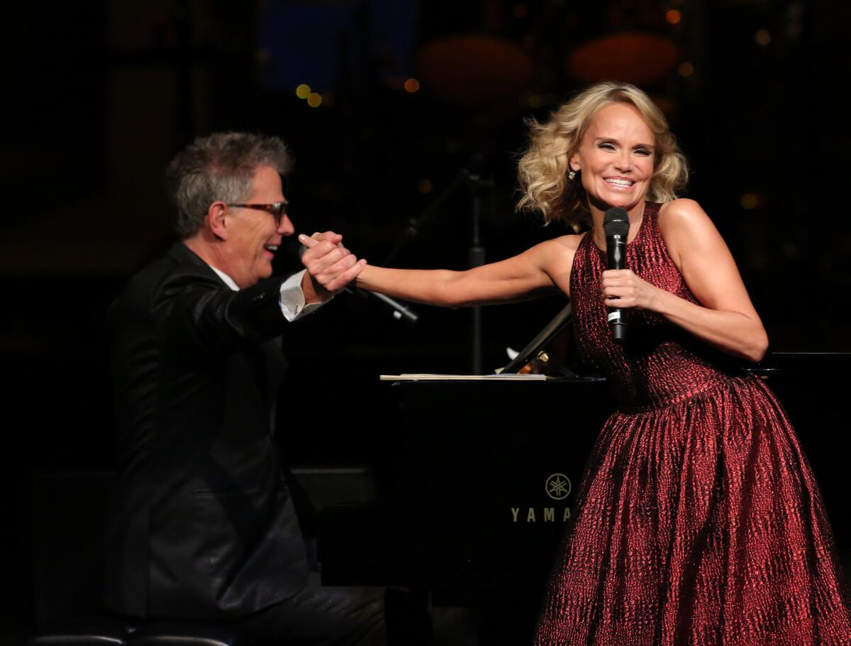 Host David Foster and singer-actress Kristin Chenoweth perform onstage at "A PBS SoCal Holiday Celebration."