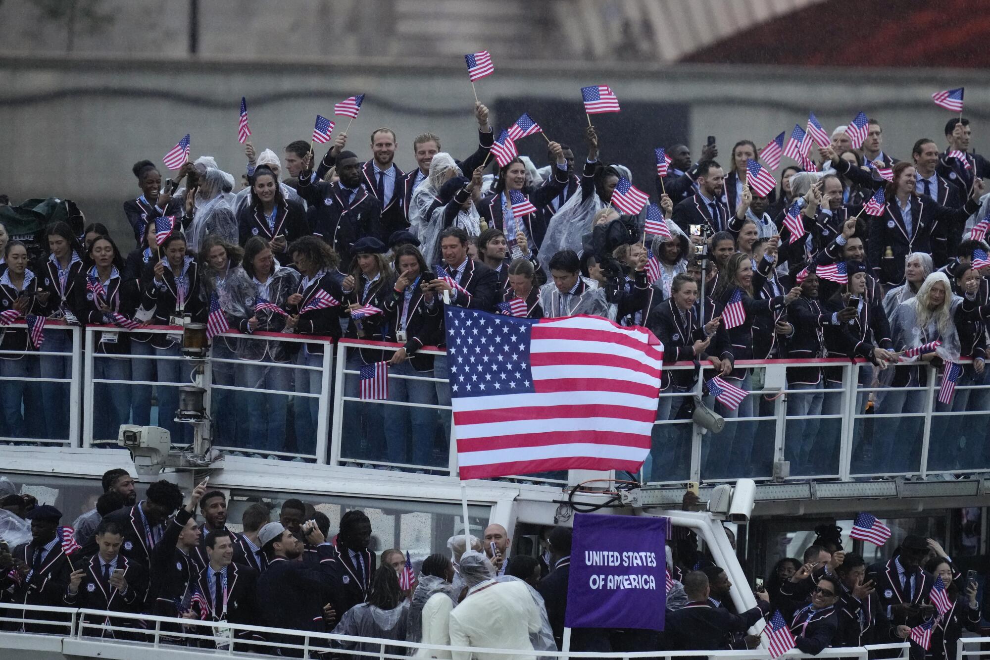 Team USA aboard a boat with an American flag waving.