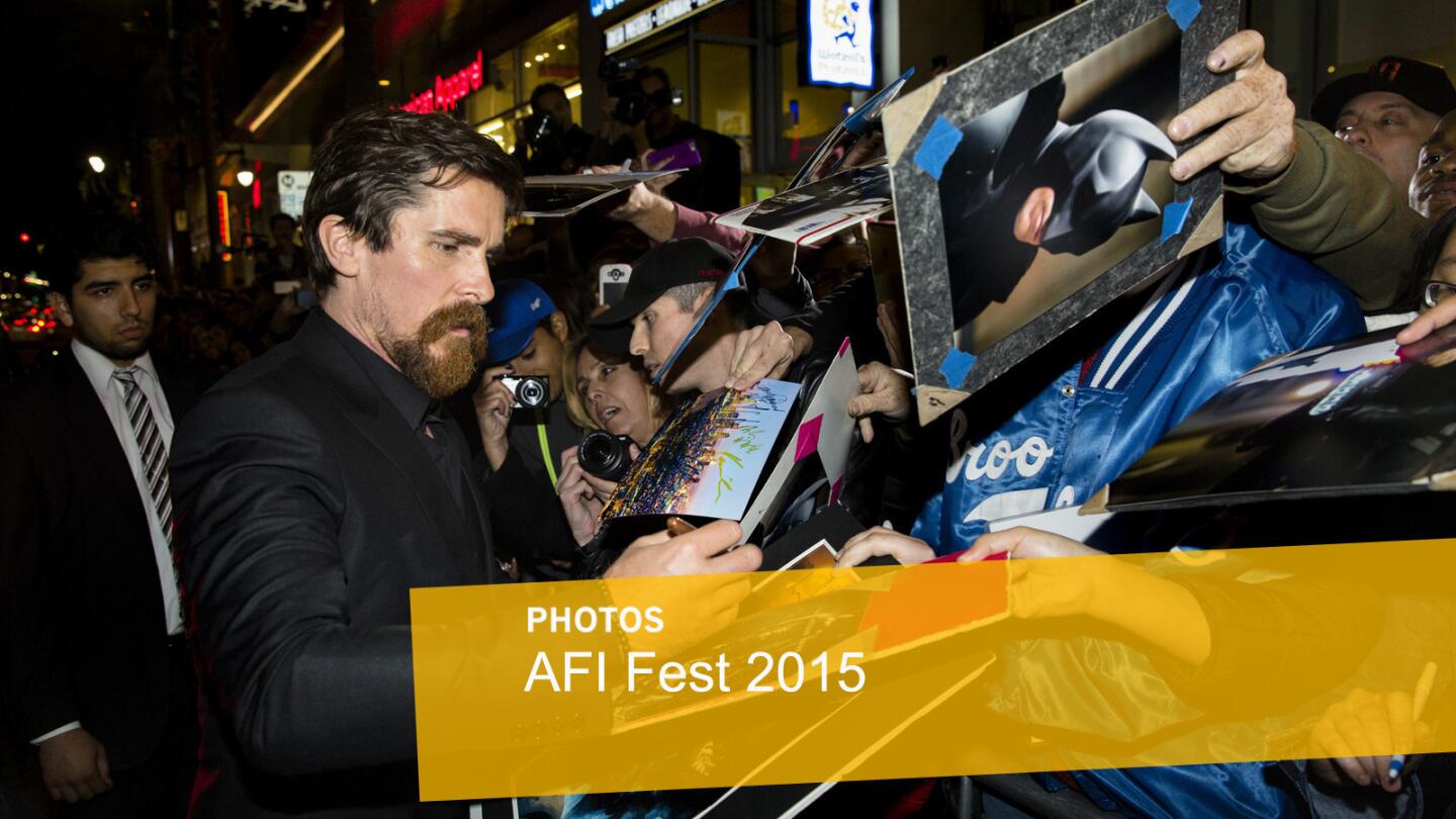 Actor Christian Bale takes pictures and signs autographs with fans lining Hollywood Boulevard before walking the red carpet for the premiere of "The Big Short" on the closing night of AFI.