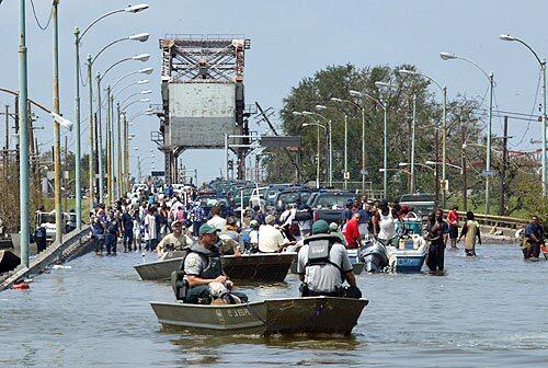 Emergency personnel at the foot of the St. Claude Street Bridge in New Orleans prepare for a rescue effort in the 9th Ward.