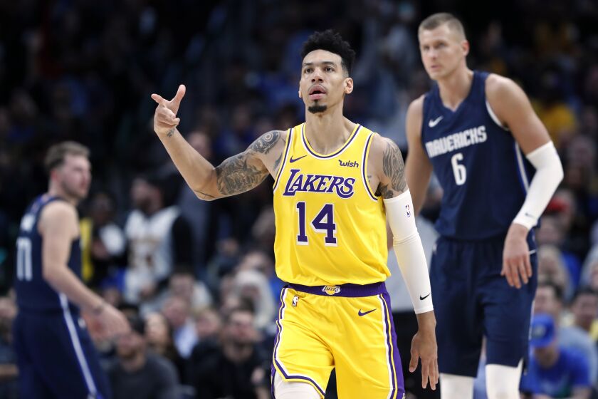 Los Angeles Lakers' Danny Green (14) celebrates sinking a basket as Dallas Mavericks' Kristaps Porzingis (6) stands nearby during the second half of an NBA basketball game in Dallas, Friday, Nov. 1, 2019. (AP Photo/Tony Gutierrez)