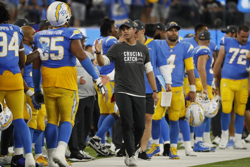 Inglewood CA, Monday, October 4, 2021 -Los Angeles Chargers head coach Brandon Staley congratulates team members as they defeat the Las Vegas Raiders 28-14 at SoFi Stadium. (Robert Gauthier/Los Angeles Times)
