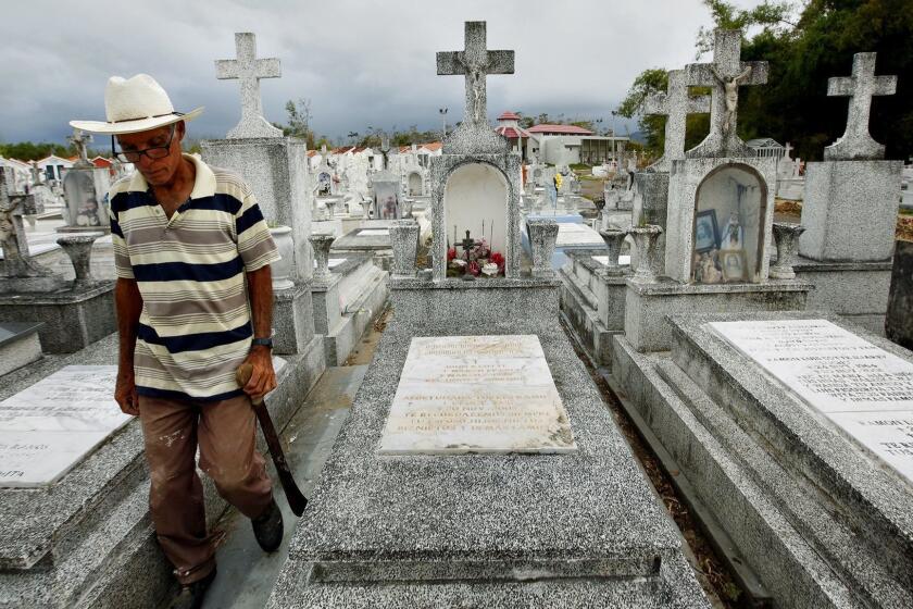 LAJAS, PUERTO RICO--Heriberto Riveiro, age 41, passed the gravesite of Leohermanijildo Cotte, who reportedly passed away because there was no electricity for his oxygen tank during hurricane Maria.