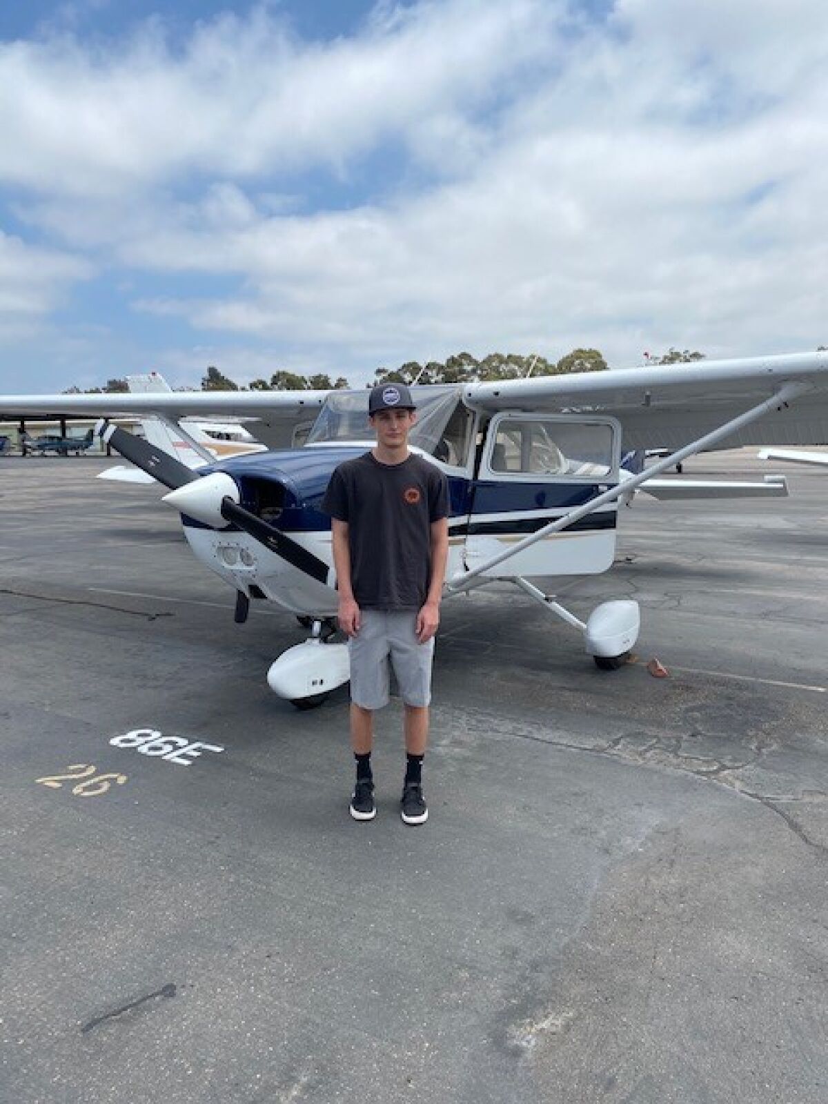 La Jolla High School student Charlie Lansky stands with the Cessna plane in which he is learning to fly.