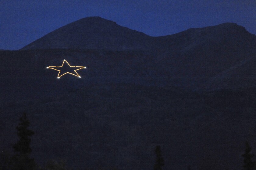 The Joint Base Elmendorf-Richardson star is Illuminated on the side of Mount Gordon Lyon on Wednesday, Sept. 11, 2019, just east of Anchorage, Alaska, in observation of the 18th anniversary of the terrorist attacks. A crew from the base went to light the 300-foot (91-meter) wide holiday star, but found that only half of the star’s 350 or so lights were working, the Anchorage Daily News reported. Airmen from the 773rd Civil Engineer Squadron Electrical Shop haven't been able to figure out what was wrong and repair the lights, but they plan to work through the week, if necessary, base spokesperson Erin Eaton said. (Bill Roth/Anchorage Daily News via AP)
