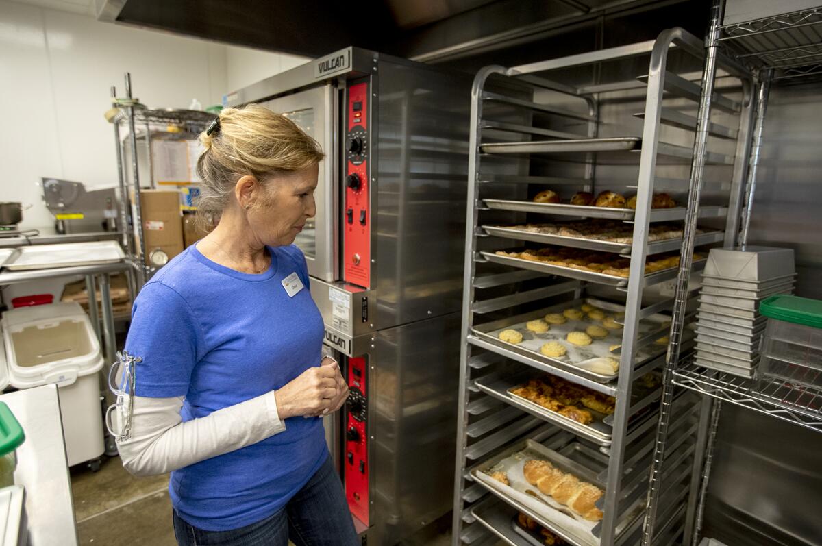 Cheryl Honig looks at freshly baked goods at the Blessed Braid in Irvine.
