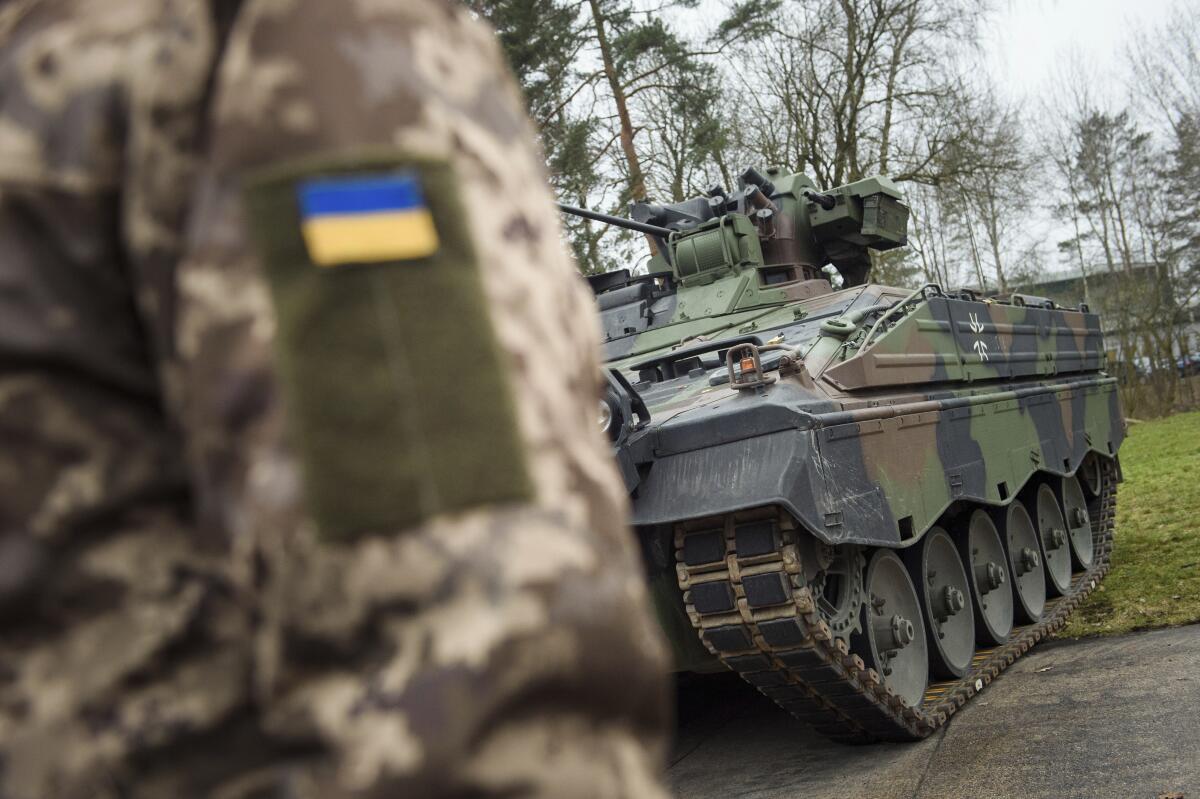 Ukrainian soldier's arm patch and a Marder infantry fighting vehicle