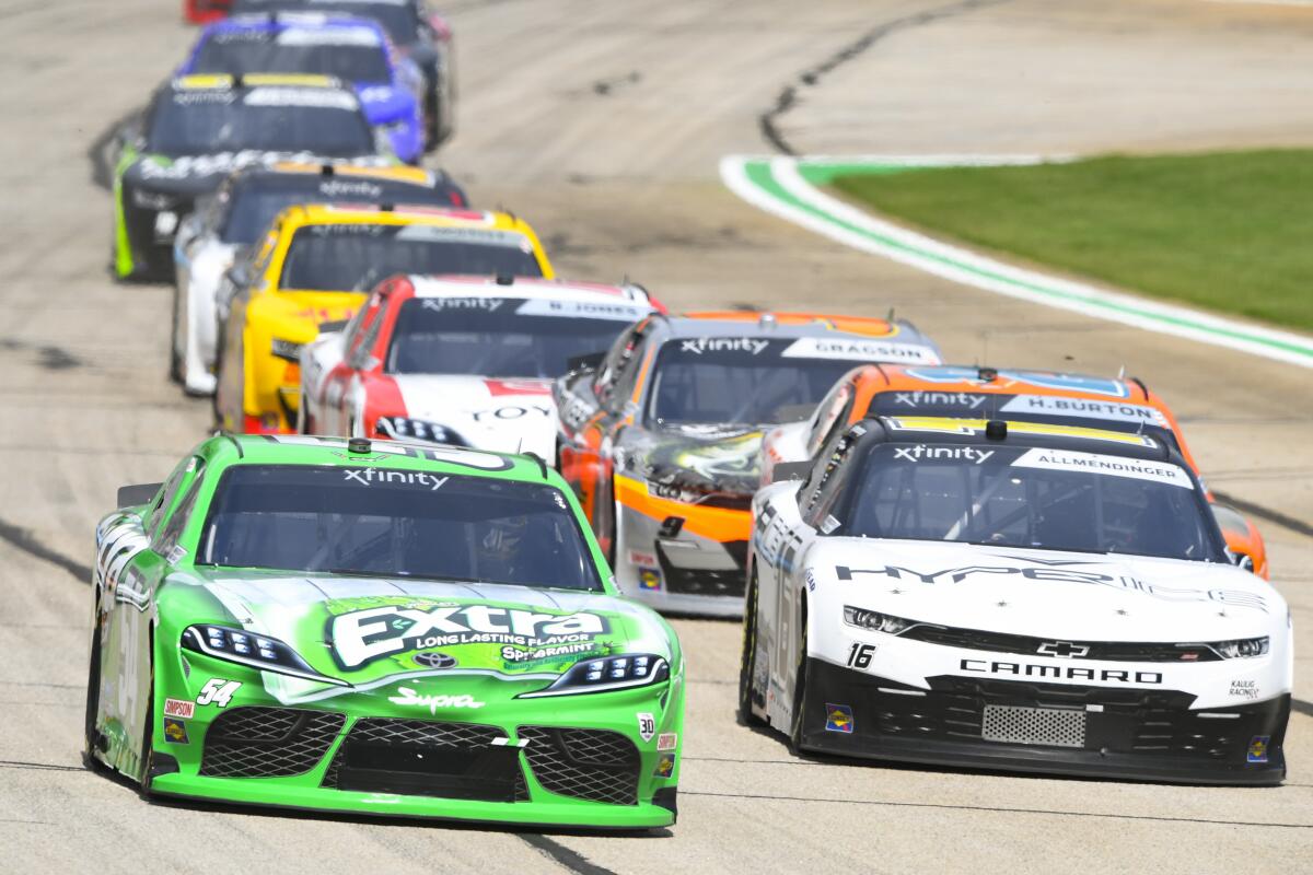 Kyle Busch, left, leads A.J. Allmendinger, right, as they come out of the first caution.