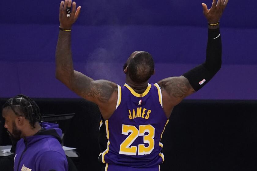 Lakers star LeBron James throws chalk in the air before his return to the court on April 30, 2021, at Staples Center.