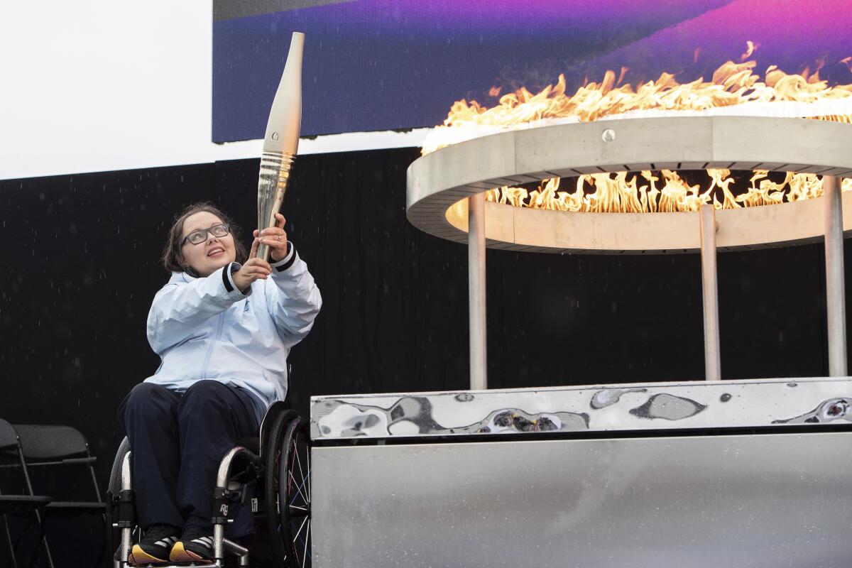 British Paralympian Helene Raynsford holds the Paralympic Torch during the flame-lighting ceremony in Stoke Mandeville