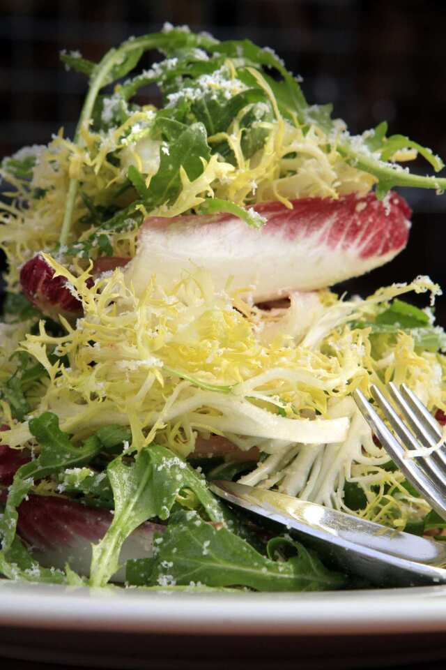Tricolore salad with Parmigiano Reggiano and anchovy dressing.