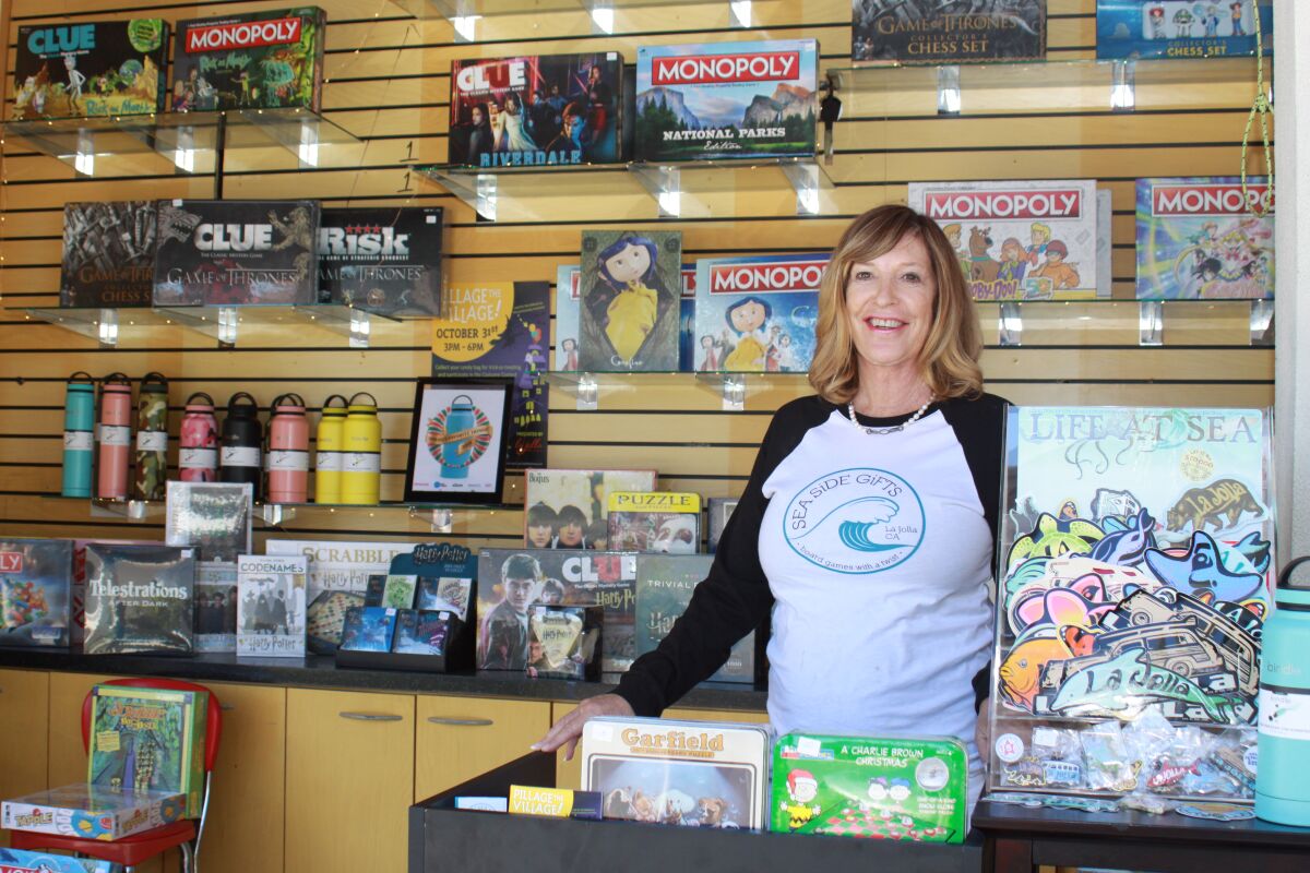 After operating her business distributing City- and themed- “Monopoly” and “Clue” games for more than two decades, La Jolla resident Shawn Chapin has opened her first pop-up stand a few weeks ago to offer specialty board games, specialty water bottles, stickers that read “La Jolla” with proceeds that go toward ocean clean-ups and more. It is a kiosk located on the corner of Herschel Avenue and Prospect Street. “I’m licensed by Hasbro to produce these games, and I started 25 years ago with La Jolla-opoly,” she said. “Now we have ‘Game of Thrones’ and ‘It’ Monopoly games that are really popular. I decided to open a pop-up because I live in La Jolla and thought this was a great location, and everyone loves games. There is nothing like this in town, so we’re excited to roll the dice!”