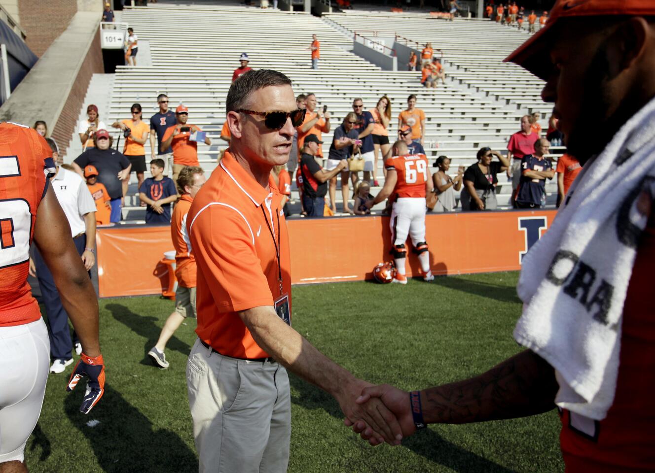 Athletic director Mike Thomas congratulates players after a game in Champaign in October.