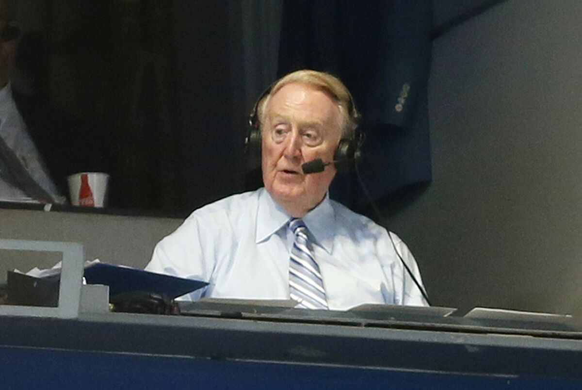 Vin Scully broadcasts from the press box at Dodger Stadium during a game between the Dodgers and Colorado Rockies on Sept. 14.