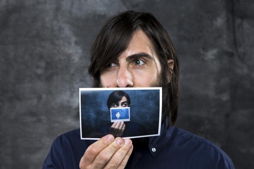 Actor Jason Schwartzman, from the new film, "The Overnight," is photographed holding a picture of himself before taking part in a panel discussion at the L.A. Times Indie Focus screening of his film.