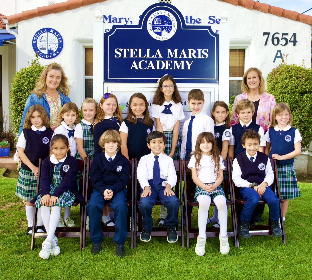 Stella Maris Academy teacher Michelle Campagna (back left), Principal Francie Moss (back right), and second-grade students