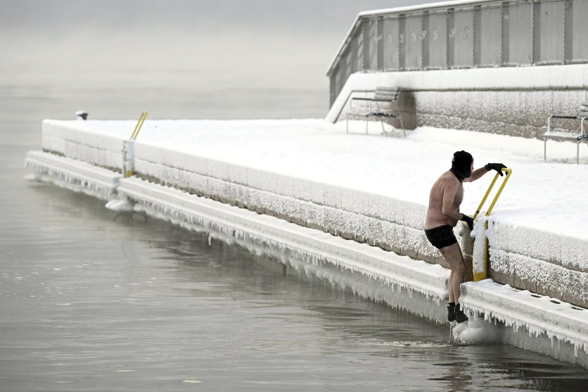 Un hombre sale del mar helado hasta el muelle, en el sur de Helsinki, Finlandia