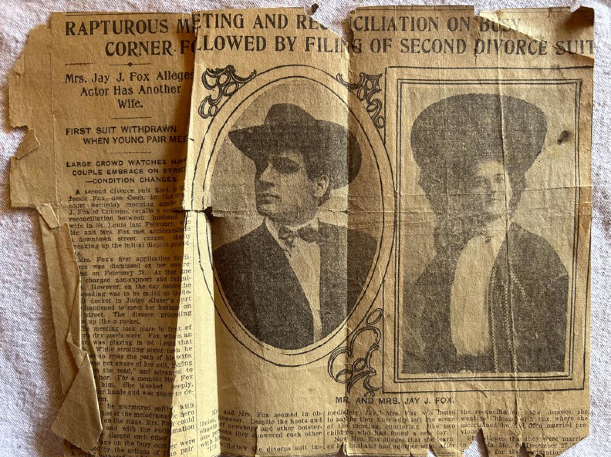 An old, folded newspaper clipping with portraits of a man and a woman