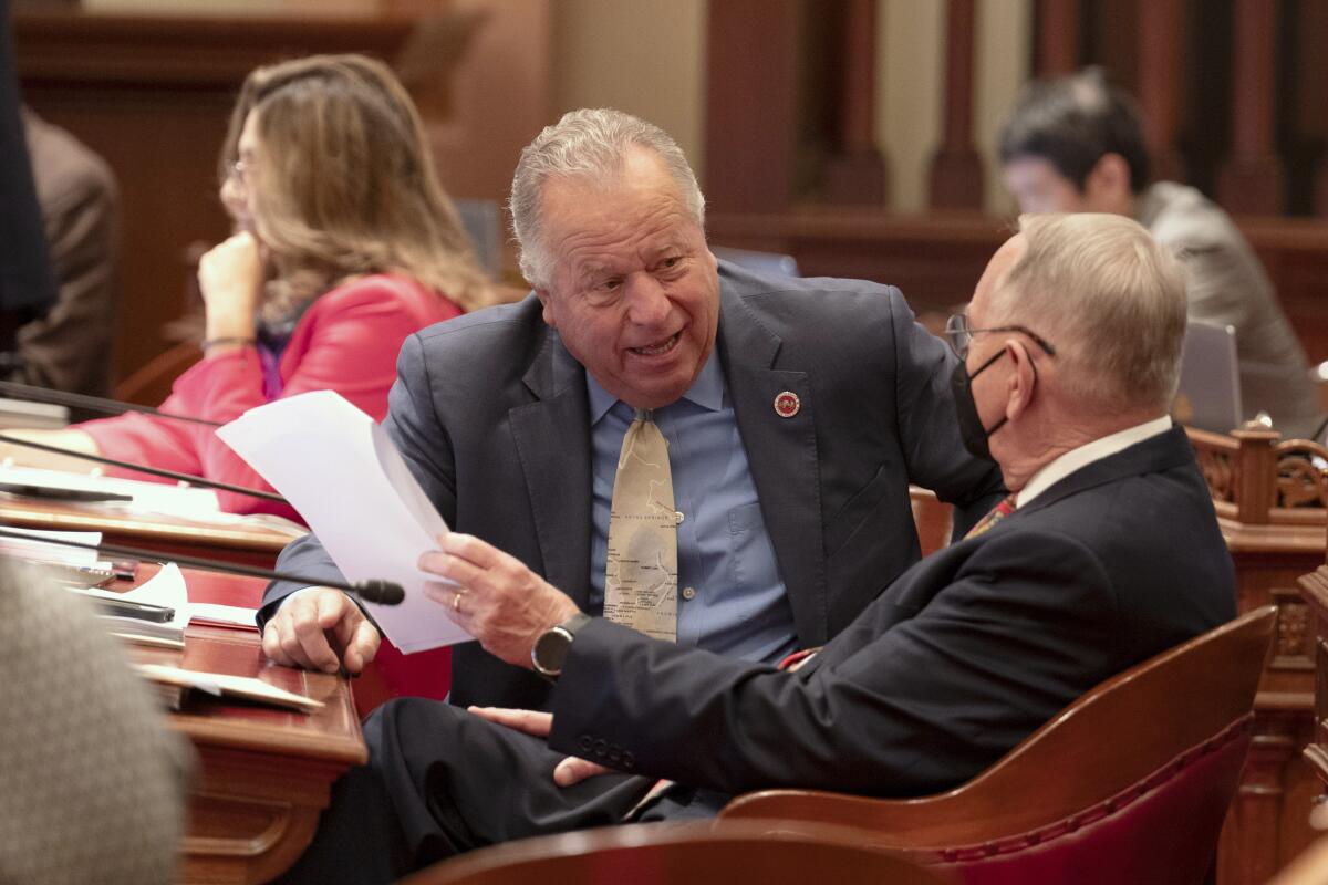 Democratic state Senators Bill Dodd, of Napa, left, and Richard Roth, of Riverside, talk at the Capitol.