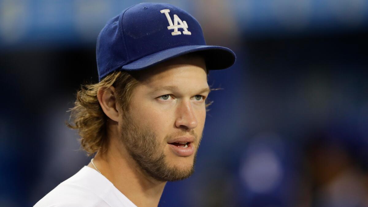 Clayton Kershaw watches from the Dodgers dugout before a Sept. 22 game against Colorado.