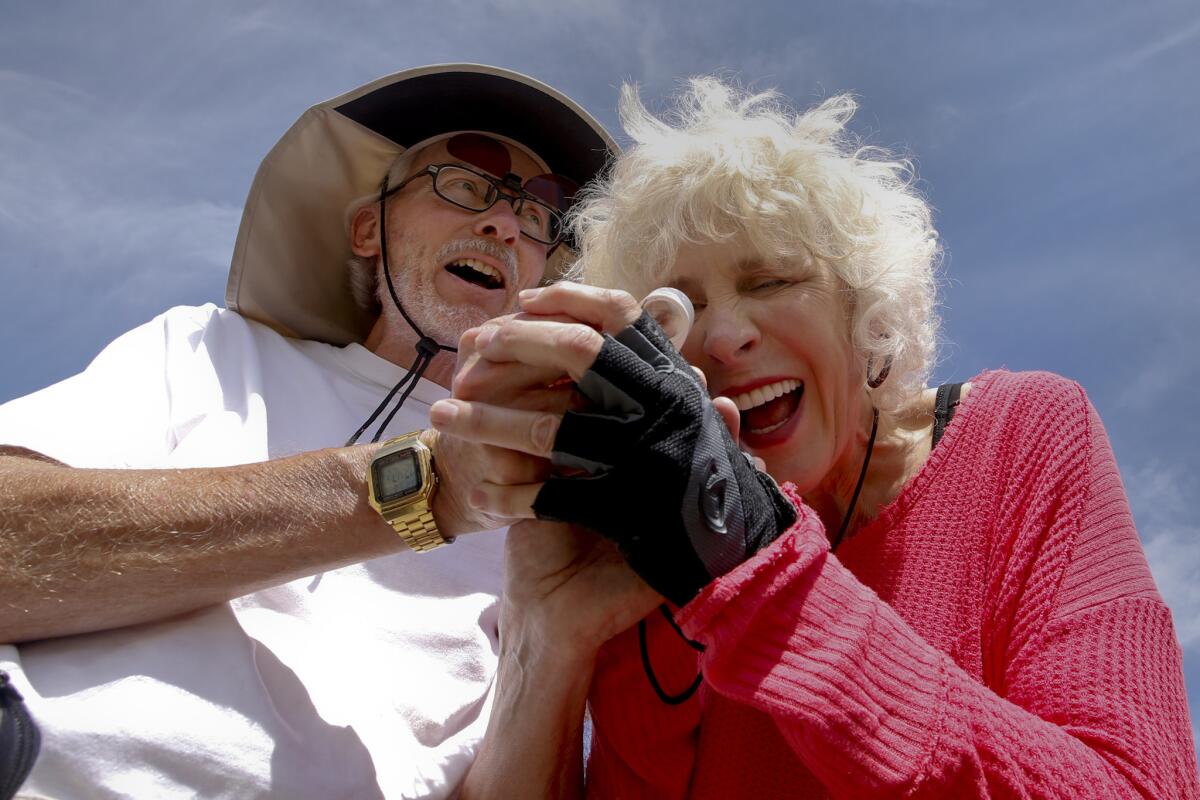 Tom Chester and Kate Harper study a tiny Cryptantha flower they found.