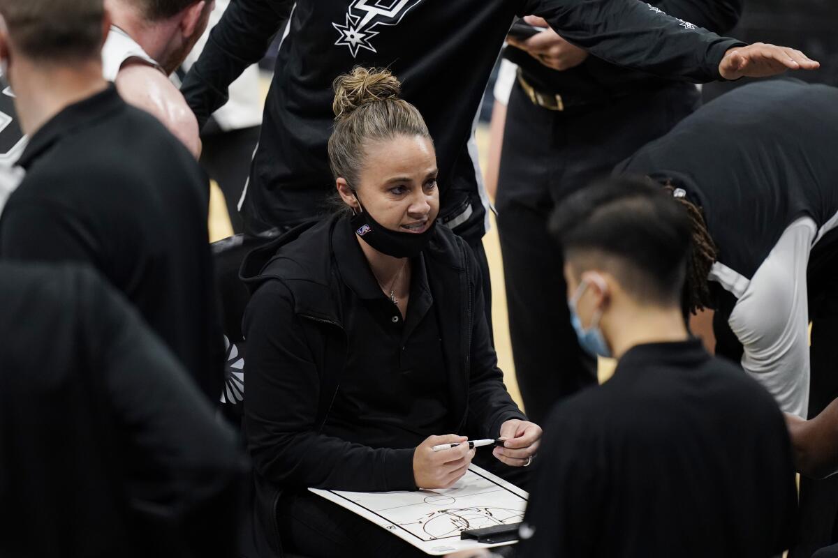 San Antonio Spurs assistant coach Becky Hammon draws up a play during a timeout.