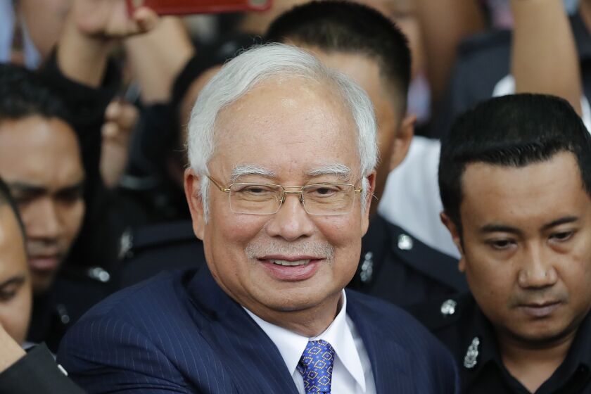 FILE - Former Malaysian Prime Minister Najib Razak gets into a car after his court appearance at the Kuala Lumpur High Court in Kuala Lumpur, Malaysia, on April 3, 2019. Malaysia's top court refused Friday, March 31, 2023 to review its decision last year to uphold former Prime Minister Najib Razak's conviction for graft and 12-year jail sentence, saying he was "the author of his own misfortune." (AP Photo/Vincent Thian, File)