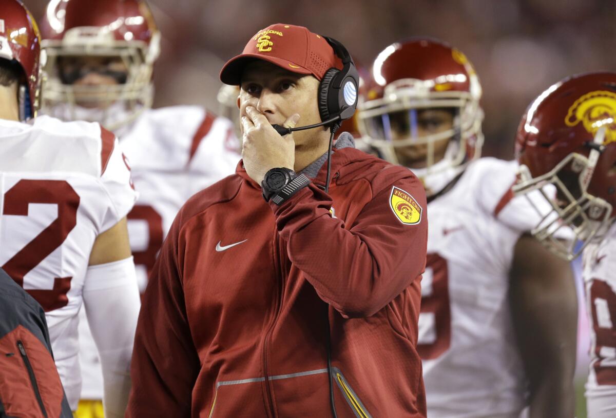 USC Coach Clay Helton, center, reacts during the first quarter of the Pac-12 Conference championship game.